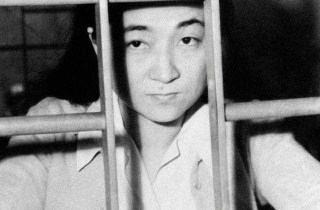 American born, Iva Toguri,  behind jail cell bars after being accused for treason