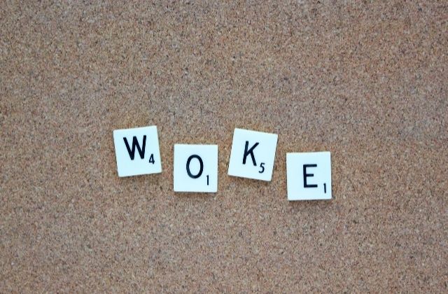 White letters spelling out the word "woke" in black text