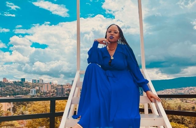 Actress and expatriates, Tiara Phalon, in a blue dress, posing in Kigali, Rwanda