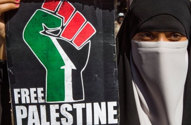 A woman holding a free Palestine Placard at a Black Lives matter protest in central London on July 18, 2020.