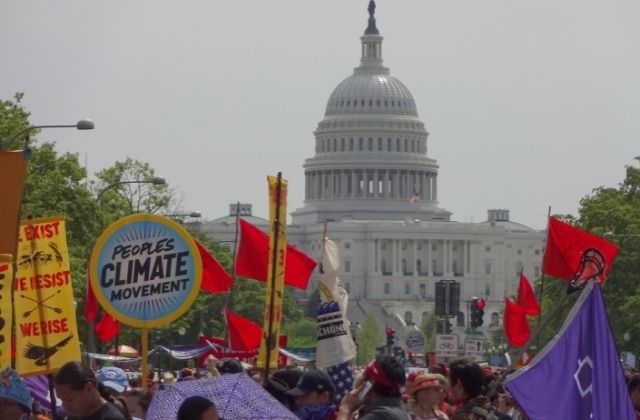 People marching outside the Capitol Building during a People's Climate March