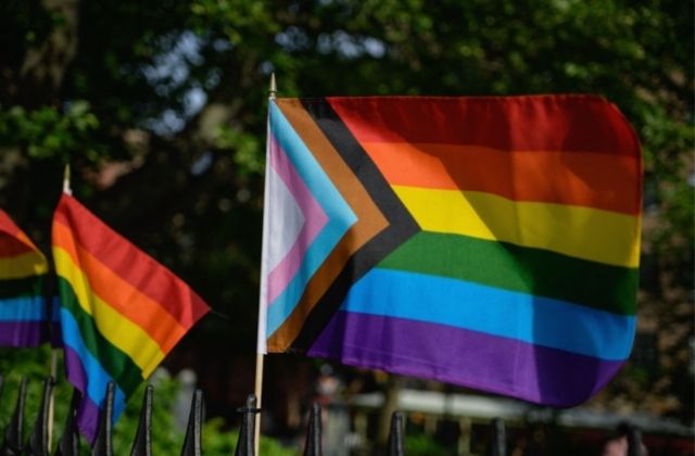  A Progress Pride flag and rainbow flags are seen at the Stonewall National Monument