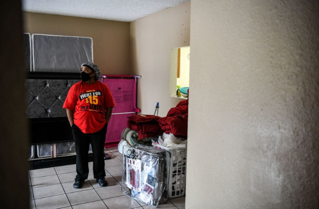 Deatrice Edie, a McDonald's employee, looks on at her home after a protest outside a branch restaurant for a raise in their minimum wage to $15 an hour