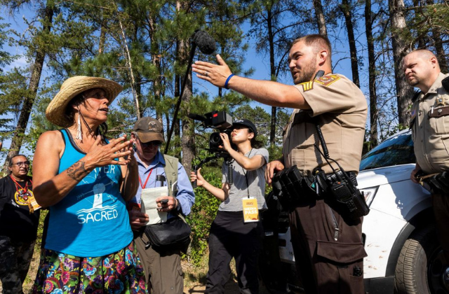 Indigenous environmental and land rights activist Winona LaDuke talks to Hubbard County Sheriff near the stock pile of Enbridge Pipeline 3 in Park Rapids, Minnesota