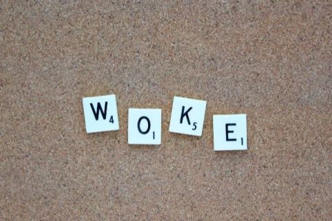 White letters spelling out the word "woke" in black text