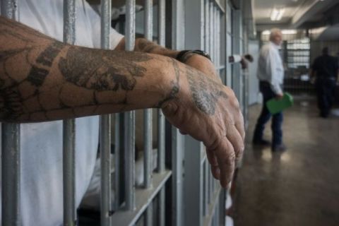 A prisoner's hands inside a punishment cell wing at Angola prison. The Louisiana State Penitentiary, also known as Angola, is nicknamed the "Alcatraz of the South" and "The Farm".