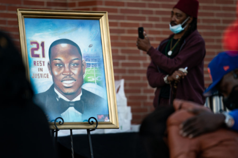 A painting of Ahmaud Arbery is displayed during a vigil at New Springfield Baptist Church 